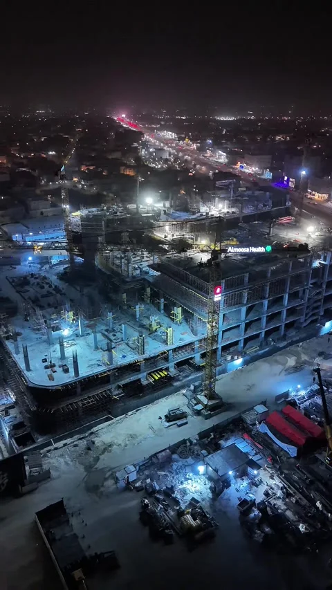 Aerial night view of construction site with cranes and city lights Stock Footage 331379933