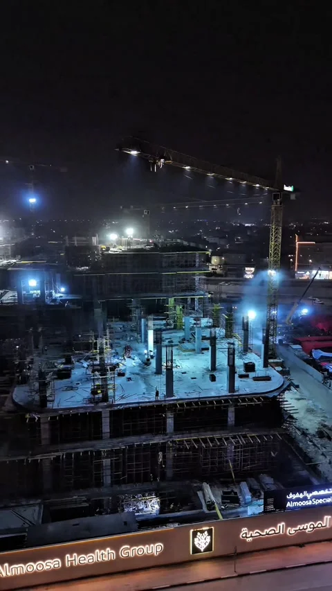 Aerial night view of construction site with cranes and city lights Stock Footage 331467405