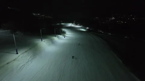 Aerial night view of illuminated ski slopes at Crystal Ski Arena in Bakuriani Stock Footage 327895099