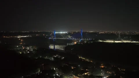 Aerial night view of lit Integration Bridge over Parana River with Ferris wheel Video stock 328997413