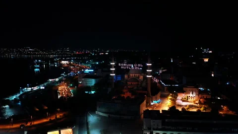Aerial night view of New Mosque. There says " be responsible, be happy" Stock Footage 136778099