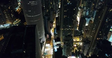AERIAL. Night view over the central Hong Kong Skyline. Skyscrapers are densely Stock Footage 85612357