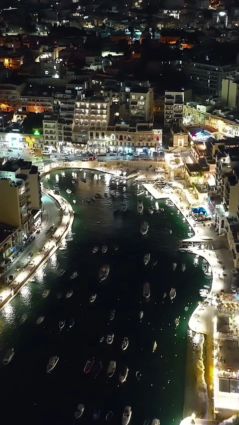 Aerial of night view of Paceville, St. Julian's city with modern towers. Malta Vidéo 343328890