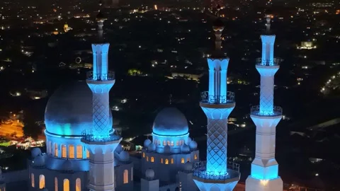 Aerial night view of Sheikh Zayed Grand Mosque dome and minarets illuminated Stock Footage 303836596
