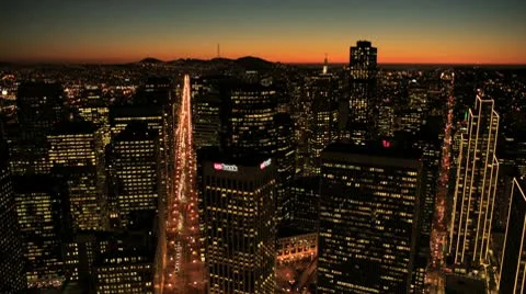 Aerial night view of skyscrapers, rooftops and city streets, USA Stock Footage