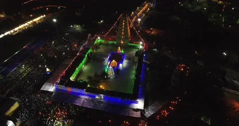 Aerial night view of a temple with light decorations and a crowd of people Stock Footage 235524253