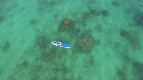 Aerial  The ocean off the coast of Hawaii a girl on the board Stock Footage 59128296