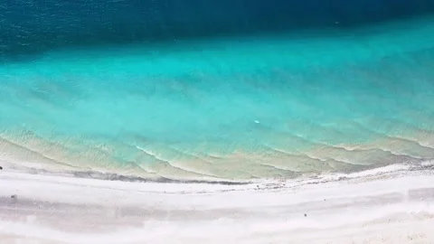 AERIAL. Ocean coast, waves and soft white sand. Video stock 135371253