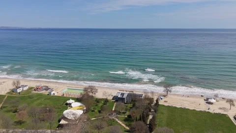 Aerial ocean surface waves hitting sandy coastline beach view Stock Footage 332938450