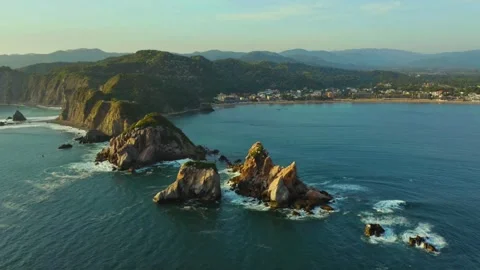 Aerial Ocean View of Dramatic Coastal Cliffs and Rocky Islands Stock Footage 319928289