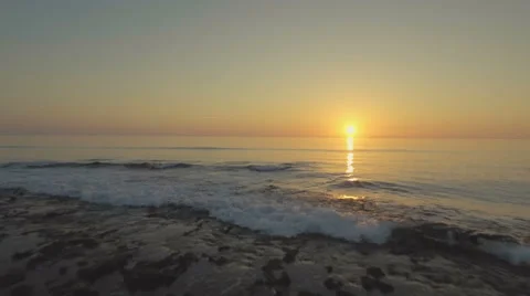 Aerial of Ocean Waves Hitting Reef with Sun on the Horizon Stock Footage 67553802