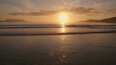 Aerial Of Ocean Waves Moving Towards Beach Shore During Sunset Video stock 86080329