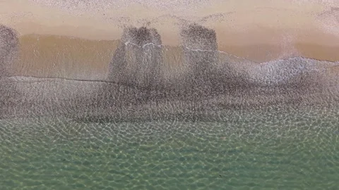 Aerial Ocean Waves Rolling onto Sandy Beach at Golden Hour Stock Footage 325292081