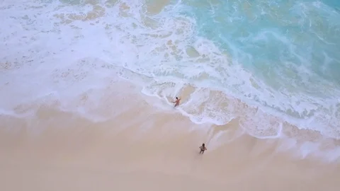 Aerial ocean waves on sand beach with people Stock Footage 109538325