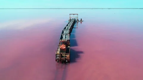 Aerial of an old train standing on the railway in salt lake Bursol. Salt mining Stock Footage 250453177