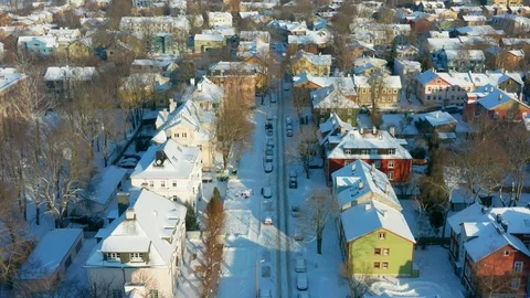 Aerial opening shot over a small street of a small suburb looking onto the sea Stock Footage 101855684
