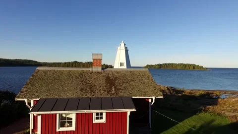 Aerial or Flyover of Wooden Buildings, White Lighthouse, Drone Video Stock Footage