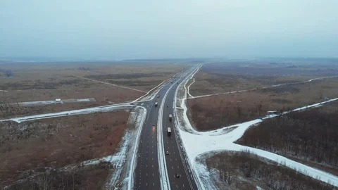Aerial or top view from drone to winter asphalt highway or motorway road in Stock Footage 99659904