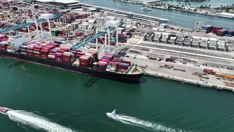 Aerial orbit above cargo ship moored under gantry cranes at PortMiami Vídeo Stock 342646581