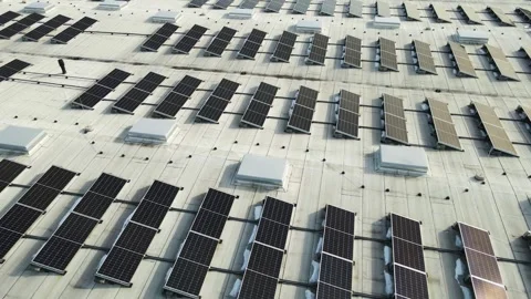 Aerial Orbit Above Rooftop Solar Arrays at Sunset on Industrial Building Vídeo Stock 332054565