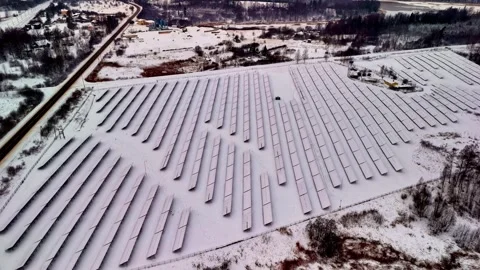 Aerial Orbit Above Snow Covered Solar Farm in Winter Rural Landscape Stock Footage 337523337