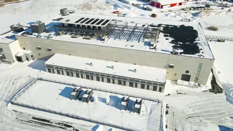 Aerial Orbit of AI Data Center With Backup Battery Storage in Snowy Estonia Stock Footage 331948042
