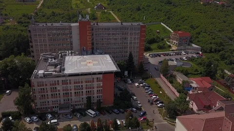 Aerial Orbit and Pull Away From Hospital With Helipad In Europe Stock Footage