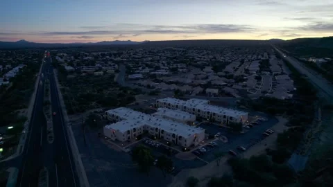 Aerial orbit of an apartment complex in a small town at dusk Stock Footage 229122245