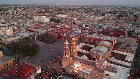 Aerial orbit approaching an illuminated cathedral at dusk Stock Footage 342061083