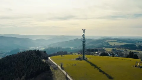 Aerial Orbit Around Cell Tower on Hilltop, Misty Landscape, Sauerland Germany 動画素材 332513360