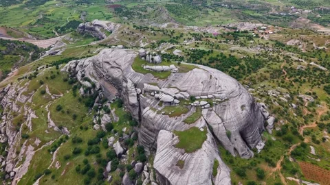 Aerial Orbit Around Massive Rock Formation in Green Valley Video stock 344180357
