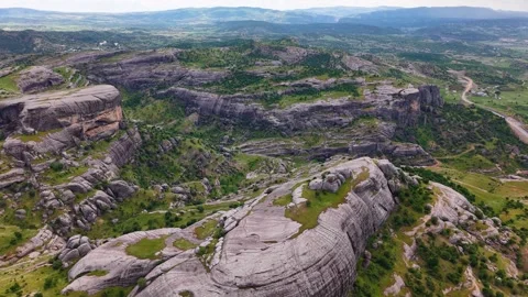 Aerial Orbit Around Massive Rock Formation With Sky Reveal Stock Footage 344183564