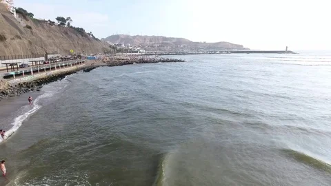 Aerial orbit around shingle beach and traffic Stock Footage 72869661
