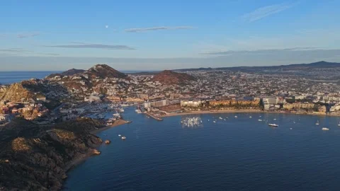 Aerial orbit of Cabo San Lucas at sunset, with its luxurious port filled with Stock Footage 334833423