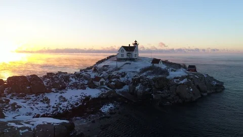 Aerial Orbit of Cold Winter Lighthouse at Sunrise in Maine 4K Stock Footage 85354989