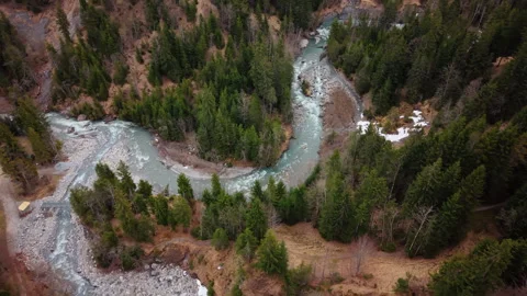 Aerial: orbit drone shot of river near Pochtenkessel deep rock funnel during Stock Footage 334690206