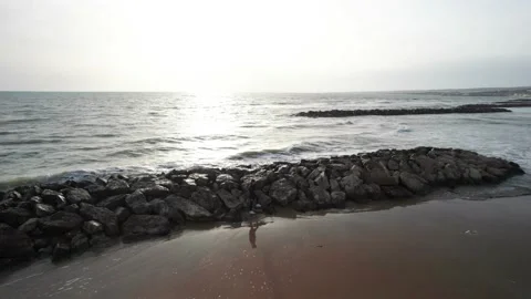Aerial orbit drone view young girl on rocks sea beach shore sunset Sicily Stock-Footage 184449165
