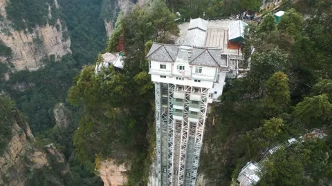 Aerial orbit establishes Bailong elevator house in Zhangjiajie China Stock Footage 263697529