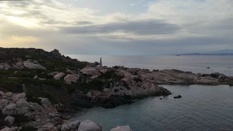 Aerial Orbit Flight Around Lighthouse and Rocks at Sunset in Sardegna It Vídeo Stock 333400051
