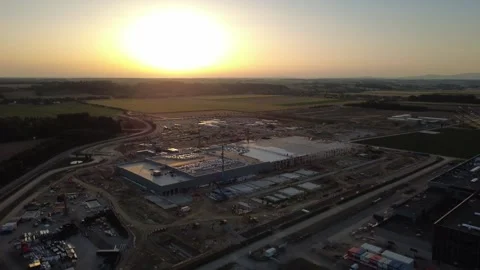 Aerial orbit of the Google data center construction site in Kronstorf at sunset Video stock 342240441