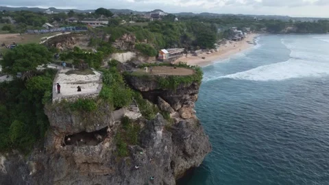 Aerial orbit left from viewpoint to coastline, Balangan Bali Stock Footage 329004413