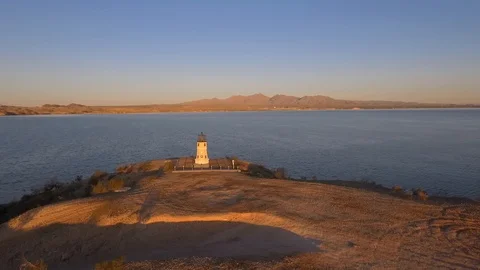Aerial orbit of a lighthouse on the shore of a lake Stock Footage 123735637