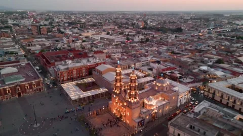 Aerial orbit of a lit cathedral and crowded square at night 스톡 동영상 342061073
