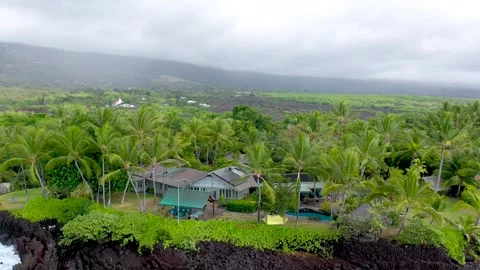 Aerial Orbit of Luxury Beachfront House on Volcanic Lava Rock Coast, Big Island Stock Footage 328387953