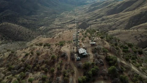 Aerial orbit of a mountain top communications tower Stock Footage 310611474