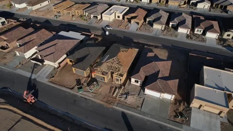 Aerial orbit of new houses under construction in a neighborhood development Stock Footage 188203553