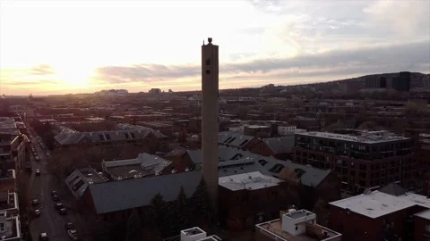 Aerial orbit, old smoke stack on the Lachine Canal, Montreal, sunset Stock Footage 158947937
