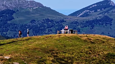 Aerial orbit over hikers resting at viewpoint on Col d'Aubisque summit Stock Footage 341536532