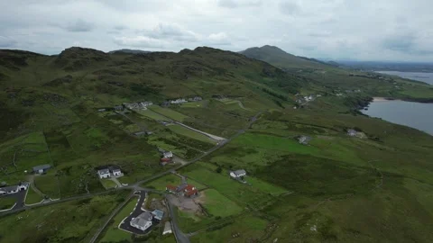 Aerial orbit over hills and scattered houses near Kilcar, Donegal Stock Footage 346745909