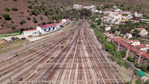 Aerial orbit over the wide rail yard of Portbou station, Catalonia Stock Footage 346288342